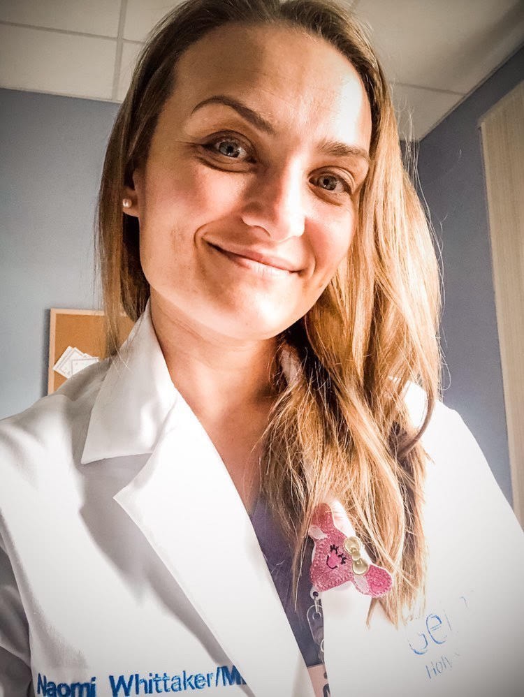 Naomi Whittaker, MD, in a white coat